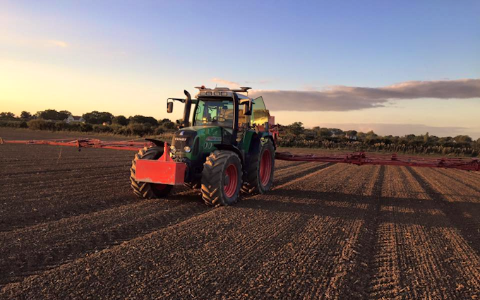 Stud farm contracting  with Tractor-mounted sprayer at United Kingdom