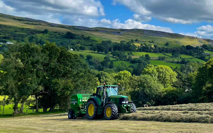 A davies agricultural contracting  with Round baler at Powys