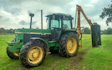 Belsham farming with Hedge cutter at United Kingdom