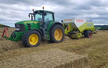 E.j & j.c.j brook agricultural contractors with Large square baler at Exeter