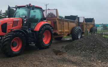 Jr king and son with Manure/waste spreader at United Kingdom