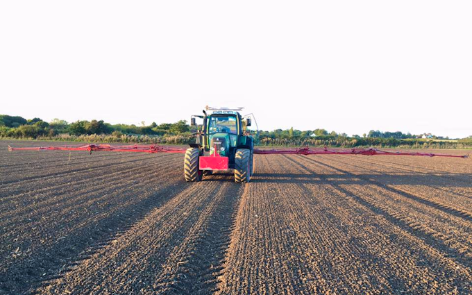 Stud farm contracting  with Tractor-mounted sprayer at United Kingdom