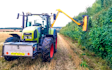Mead farms with Hedge cutter at United Kingdom