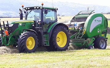 Adam & sons agri services with Round baler at United Kingdom