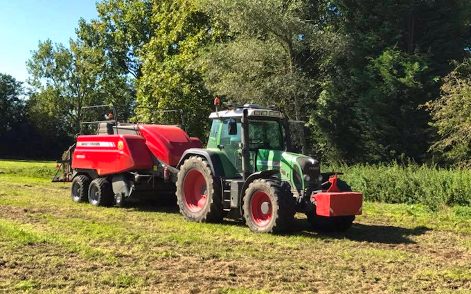 Stud farm contracting  with Large square baler at United Kingdom