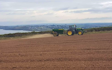 Dan hirst agricultural contractors  with Lime spreader at United Kingdom