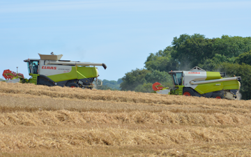 Bun symes contracting limited with Combine harvester at United Kingdom