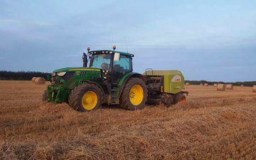 Dan hirst agricultural contractors  with Round baler at United Kingdom
