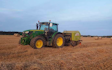 Dan hirst agricultural contractors  with Round baler at United Kingdom
