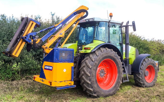 Mead farms with Hedge cutter at United Kingdom